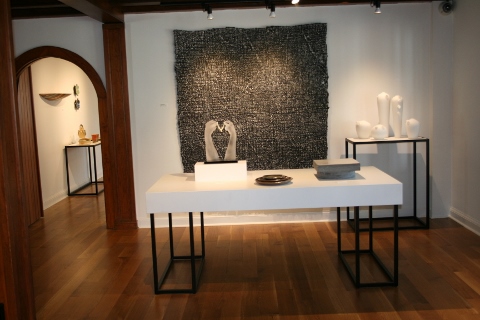 Table in gallery room with art